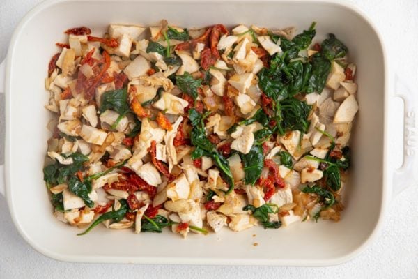 Large casserole dish with chicken and vegetables inside.