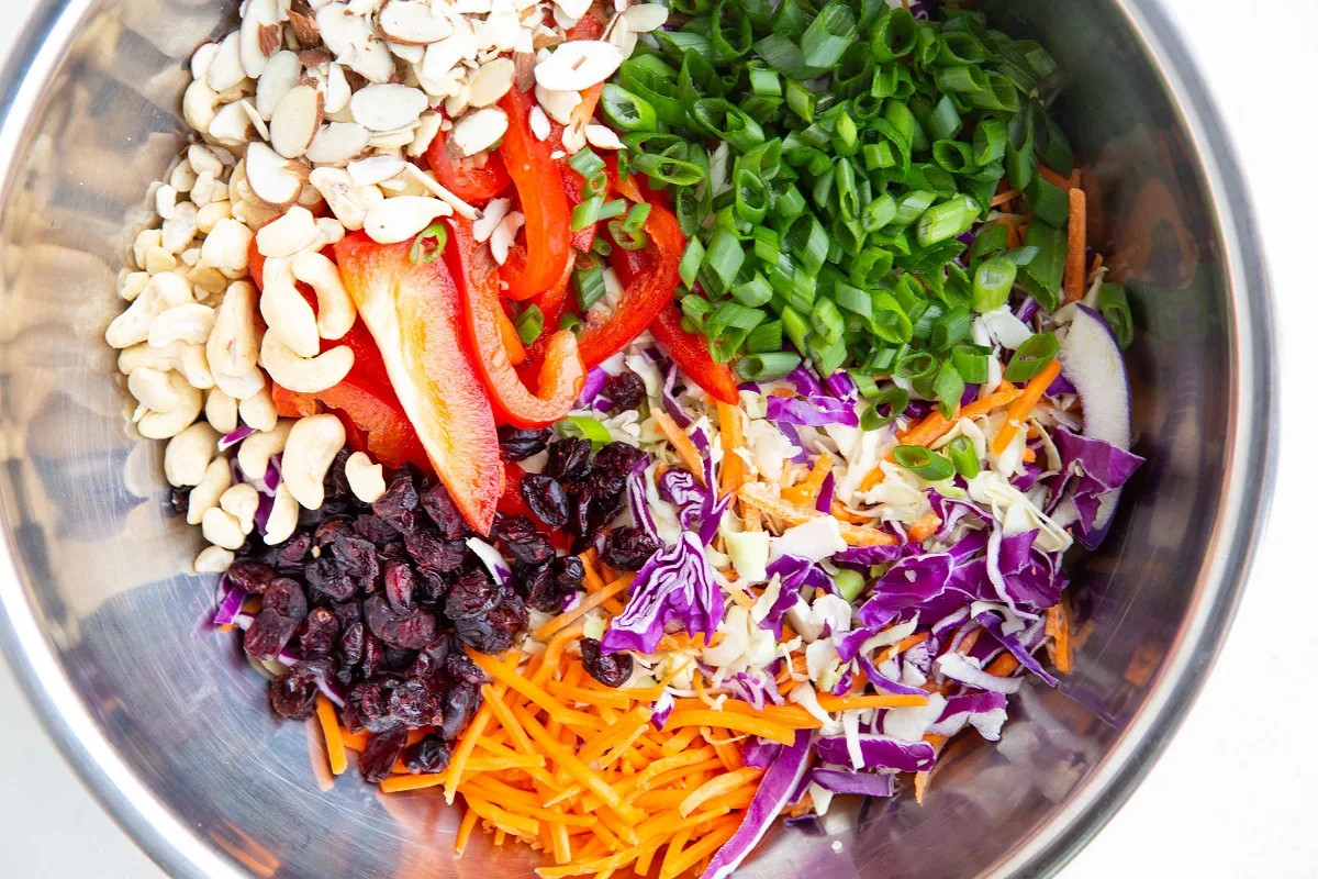 Salad ingredients in a big mixing bowl, ready to be mixed together.