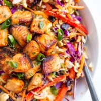 Crispy salmon chunks on top of a salad to make a full meal.