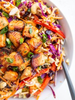 Crispy salmon chunks on top of a salad to make a full meal.