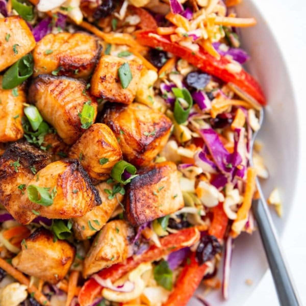 Crispy salmon chunks on top of a salad to make a full meal.