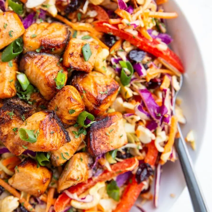 Crispy salmon chunks on top of a salad to make a full meal.