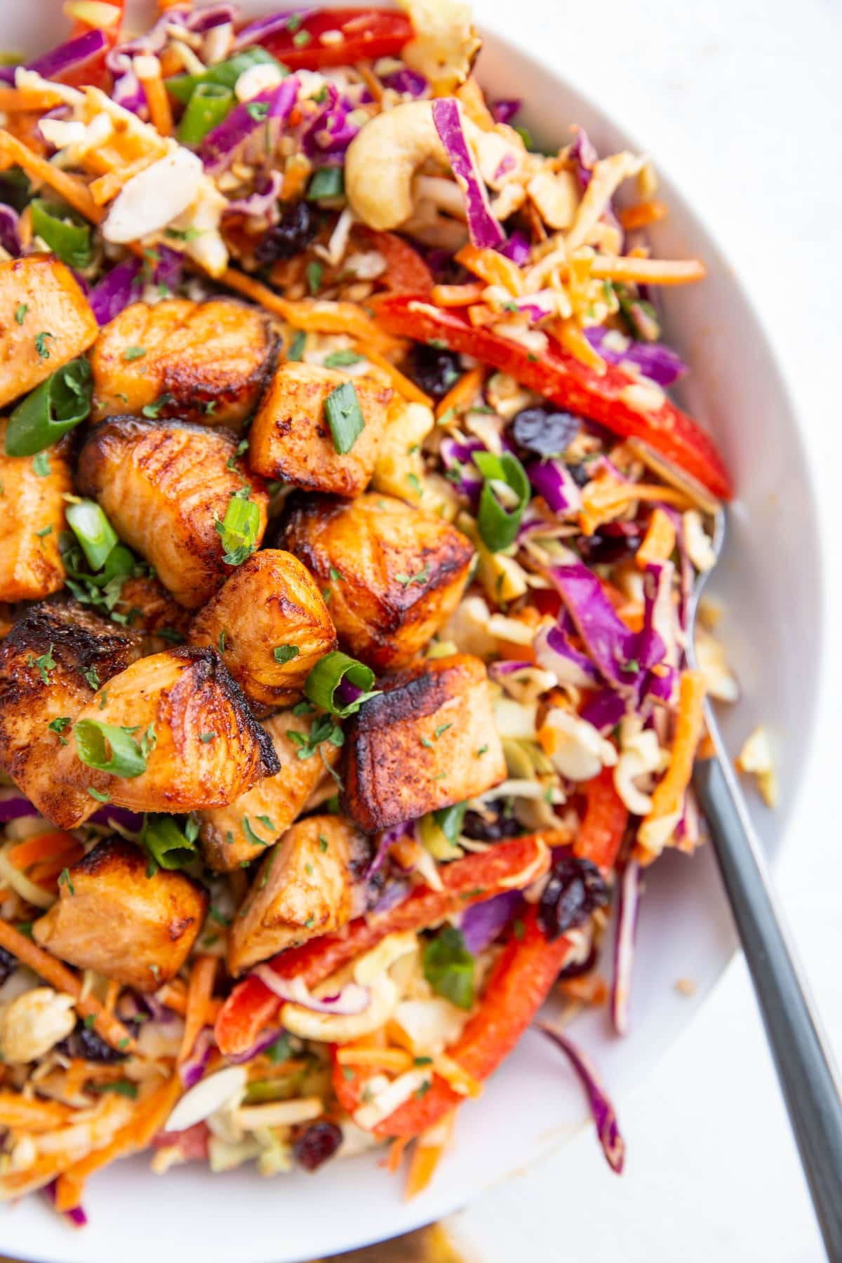 Crispy salmon chunks on top of a salad to make a full meal.