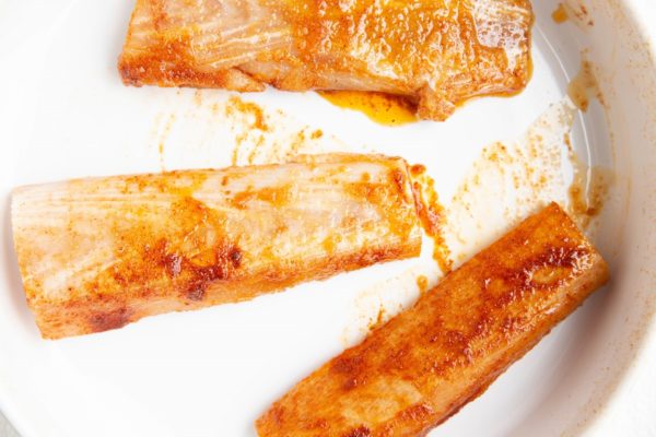 marinated raw mahi-mahi filets in a baking dish.