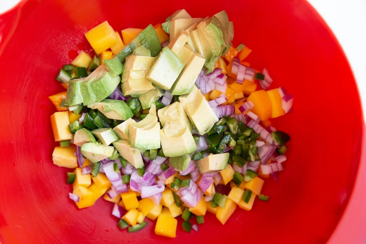 Ingredients for mango salsa in a mixing bowl.