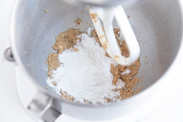 Wet ingredients and dry ingredients in a stand mixer, ready to be mixed together.