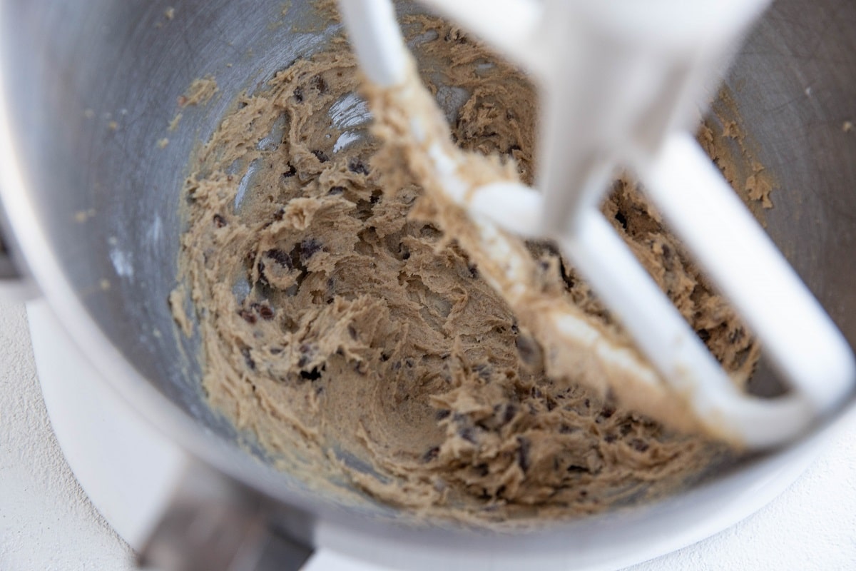 Gluten free chocolate chip cookie dough in a stand mixer.
