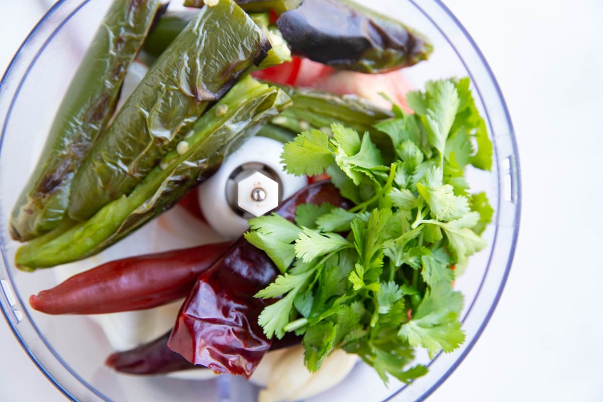 Ingredients for homemade salsa in a food processor.