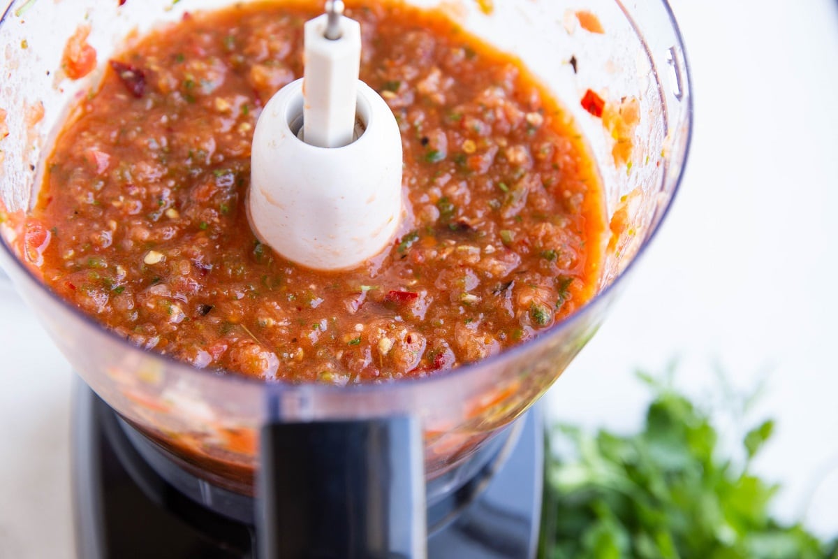 Fresh homemade salsa recipe in a food processor, ready to serve.