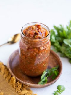 Red chili tomato salsa in a jar, ready to eat.