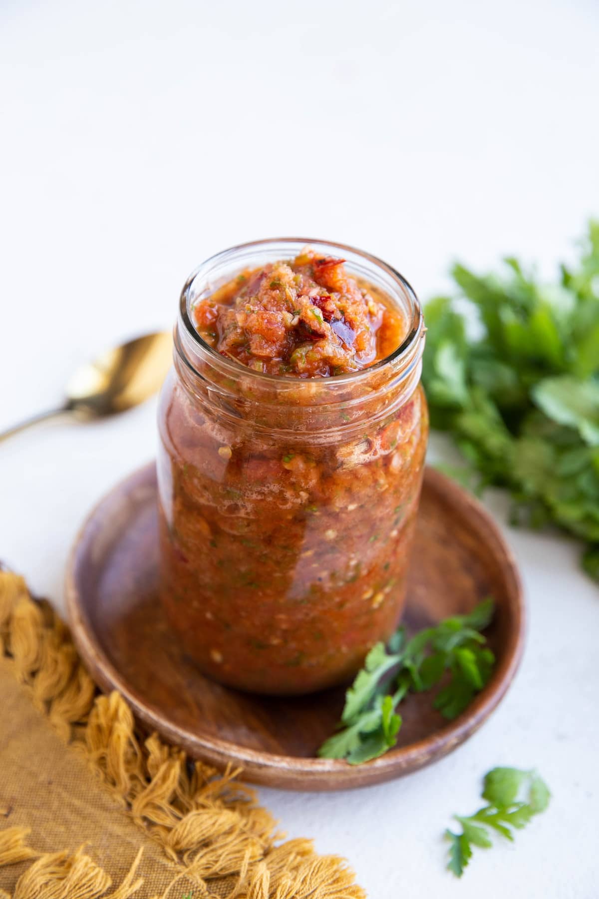 Red chili tomato salsa in a jar, ready to eat.
