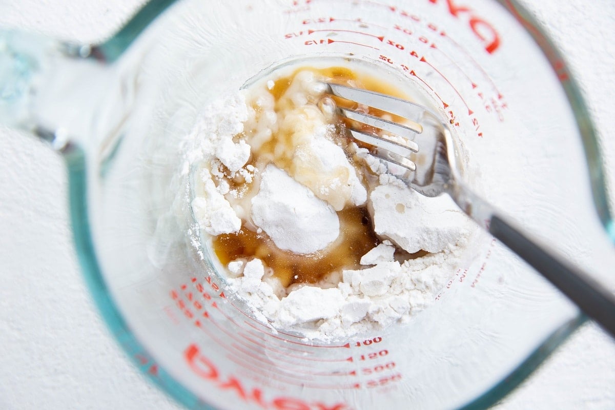 Ingredients for the biscuit dough topping in a measuring cup.