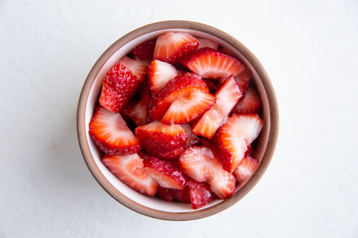 Chopped strawberries in a small ramekin.