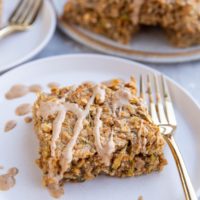 Slices of zucchini oatmeal on white plates with a plate of slices stacked in the background.