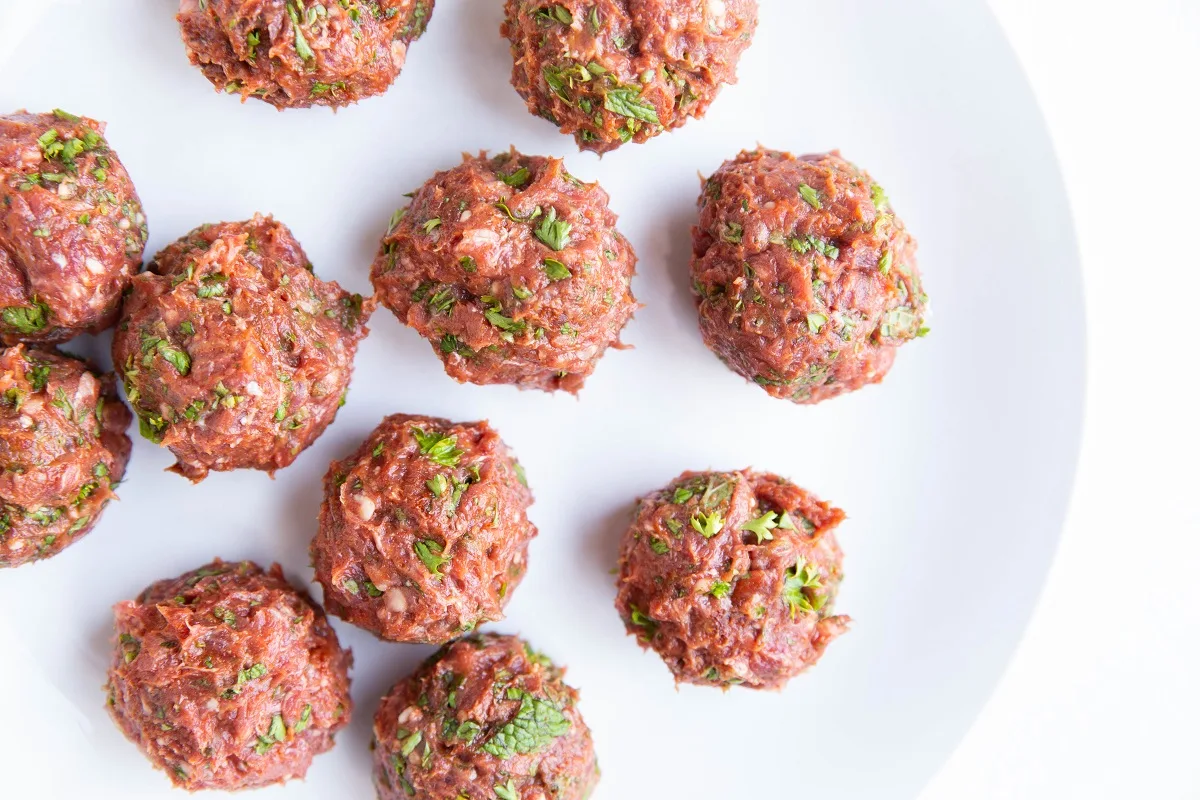 Raw meatballs on a plate.