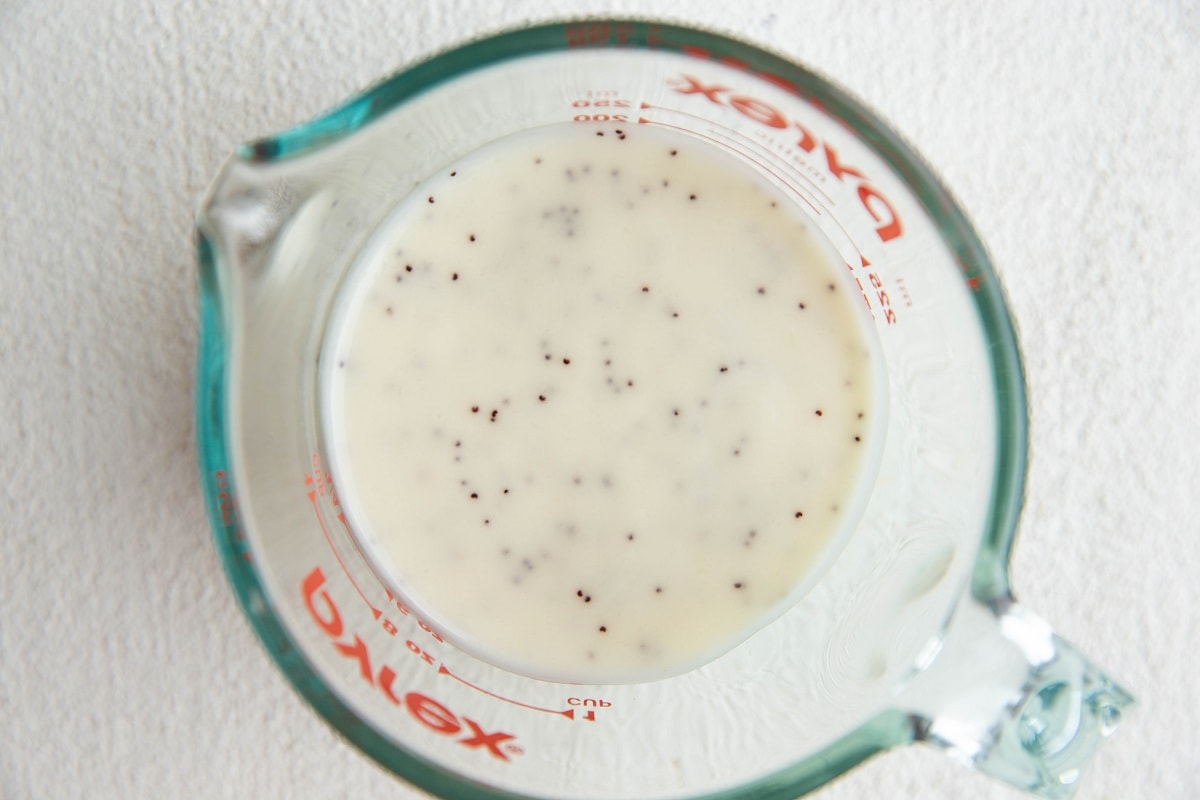 Broccoli salad dressing in a measuring cup.