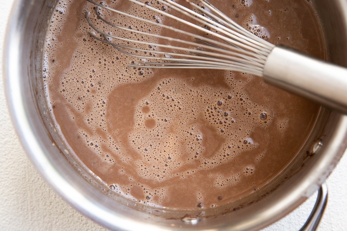 Dairy-free chocolate ice cream base in a saucepan, ready to freeze.