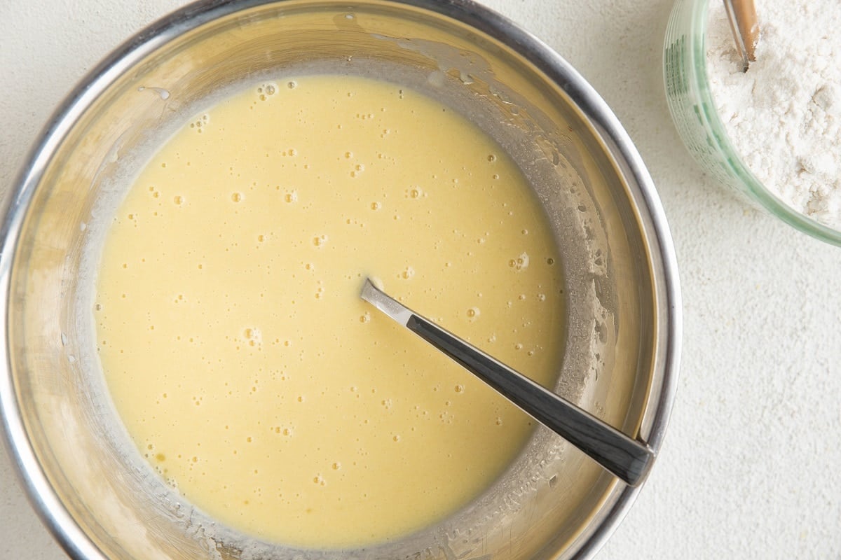 Wet ingredients mixed up in a mixing bowl.