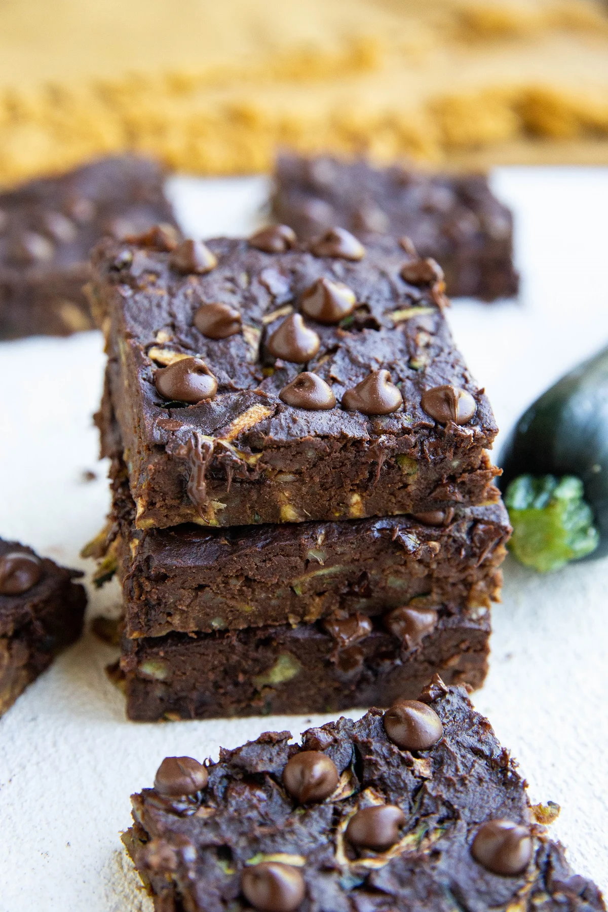 Stack of zucchini brownies on a white background.