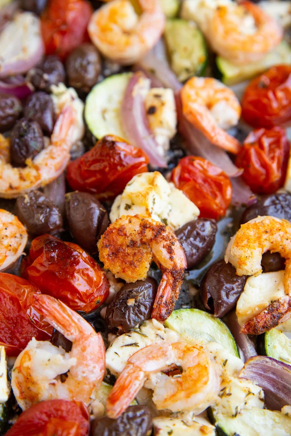 Shrimp and vegetables on a baking sheet, ready to eat.