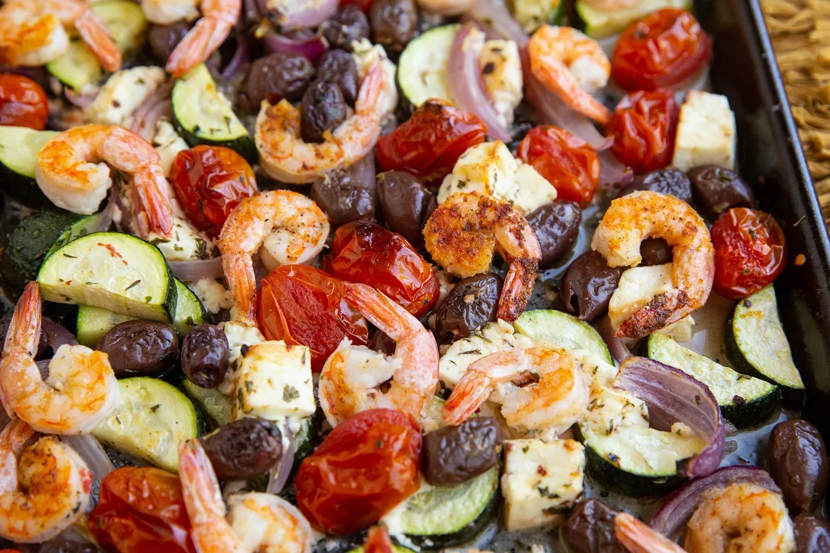 Shrimp and vegetables on a large baking sheet, fresh out of the oven.