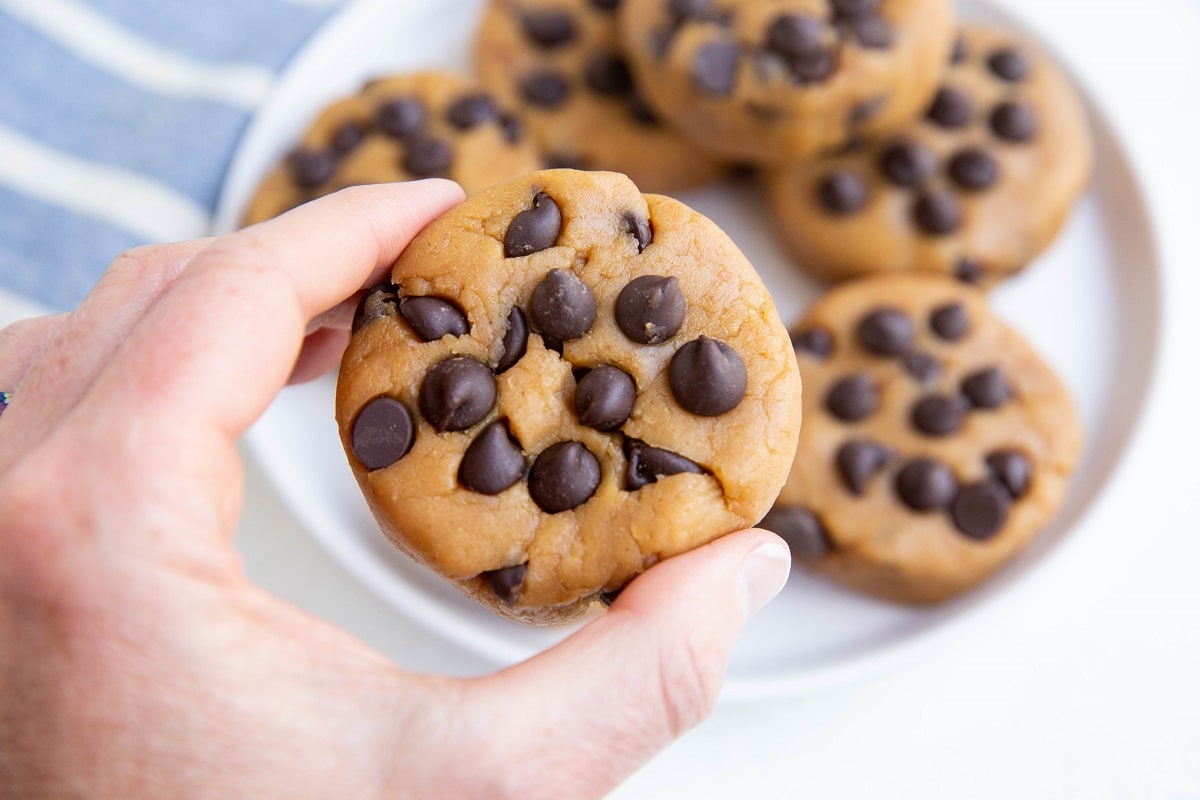 Hand holding a disc of chickpea cookie dough.