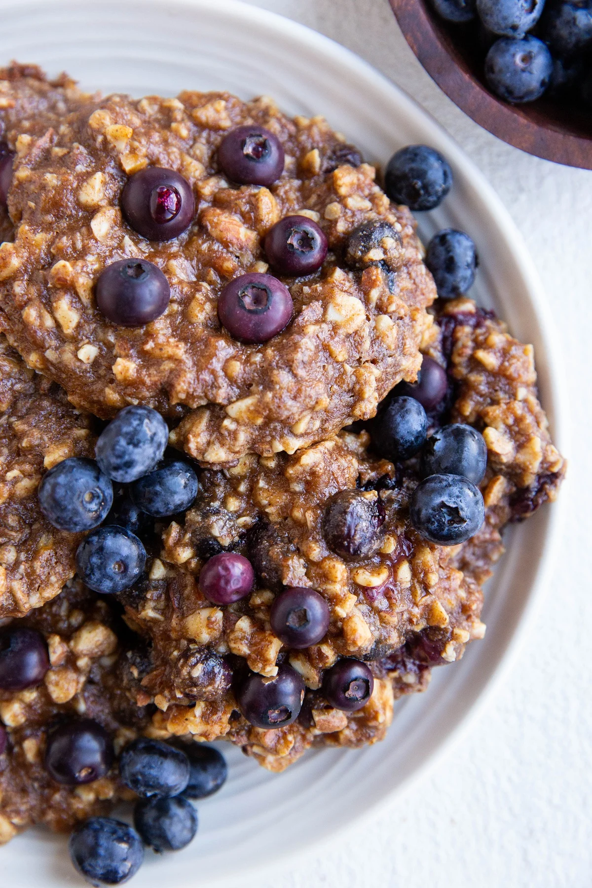 White plate with blueberry banana nut cookies on top.