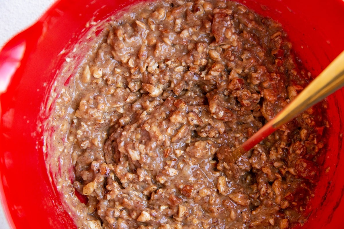 Cookie dough mixture for grain-free banana blueberry cookies in a mixing bowl.