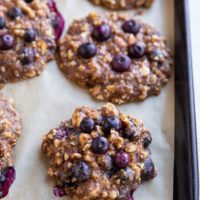 Nutty Banana Blueberry cookies on a large baking sheet, fresh out of the oven.