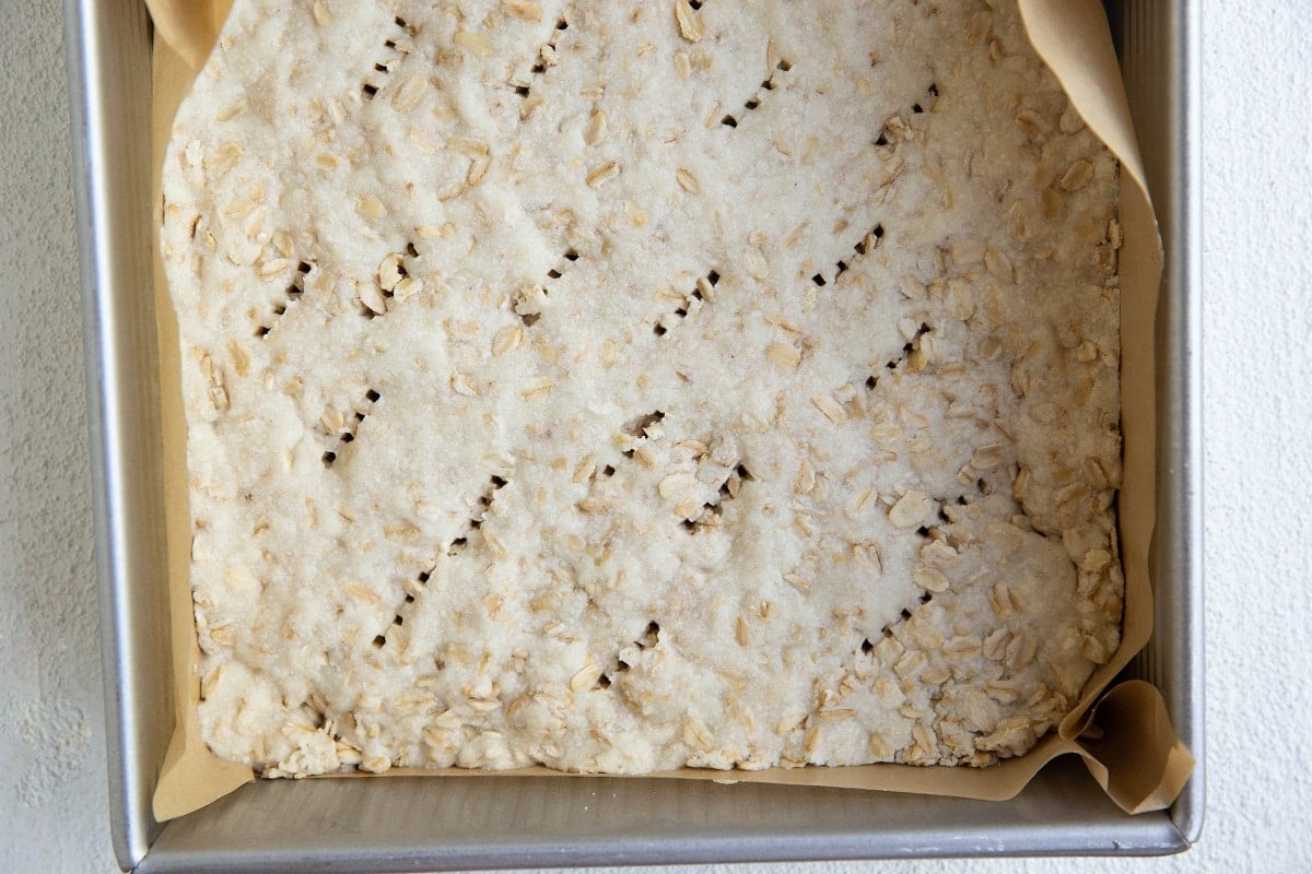 Shortbread crust in a baking pan.