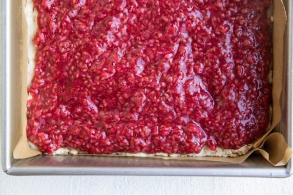 Raspberry mixture on top of crust in a square dish.