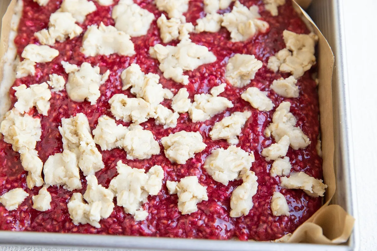 Sprinkle the remaining crumble topping on top of the raspberry layer