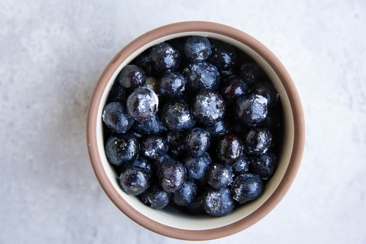 Small bowl with fresh blueberries inside.