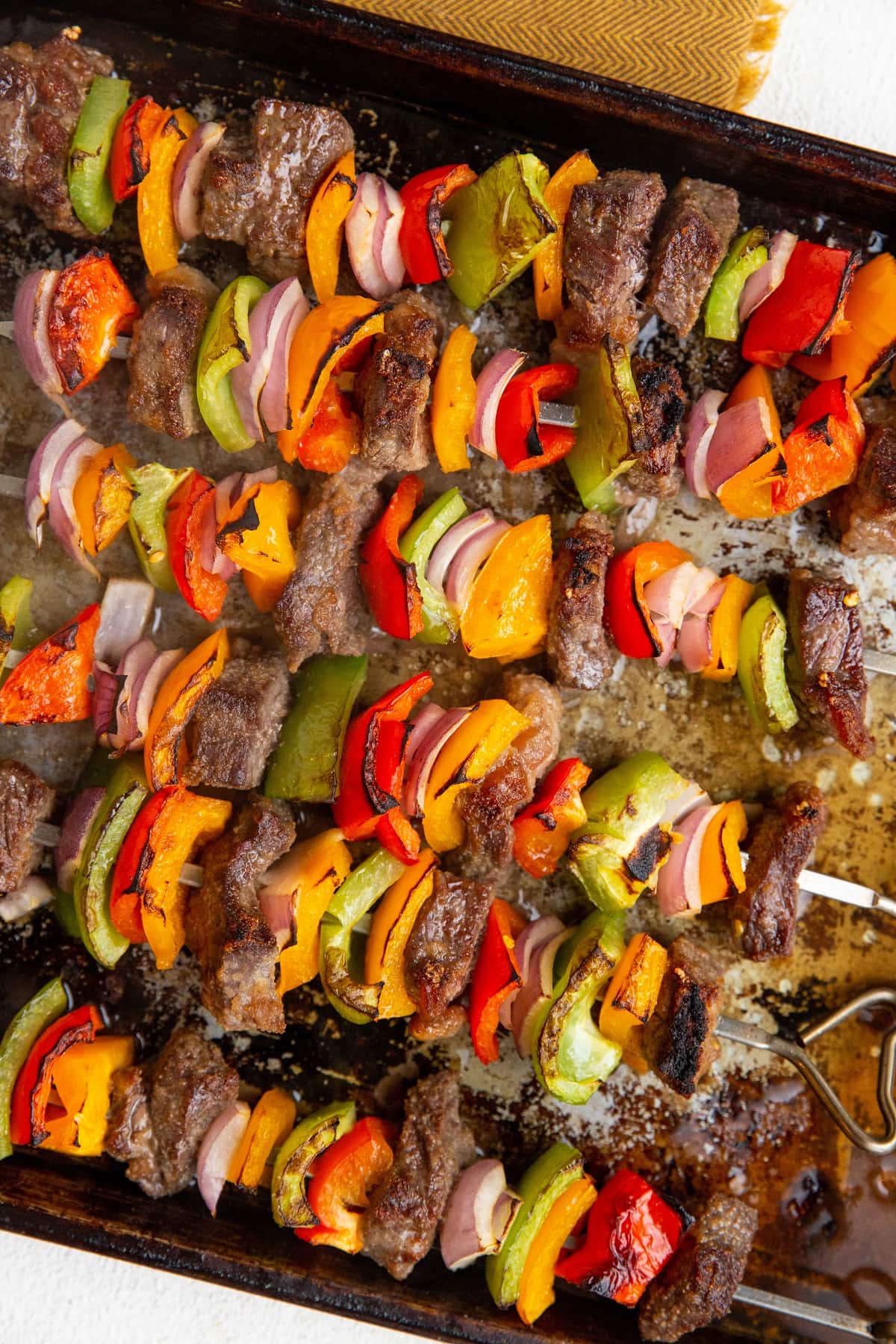 Steak Kabobs on a large baking sheet, fresh out of the oven.