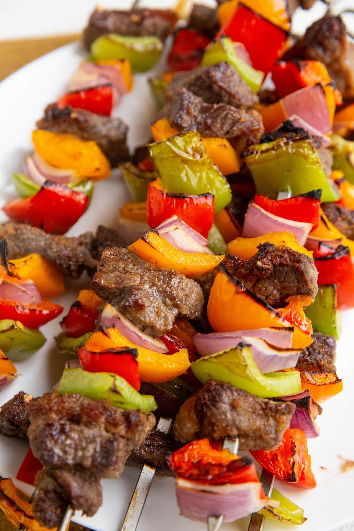 Beef kabobs on a plate, ready to serve.