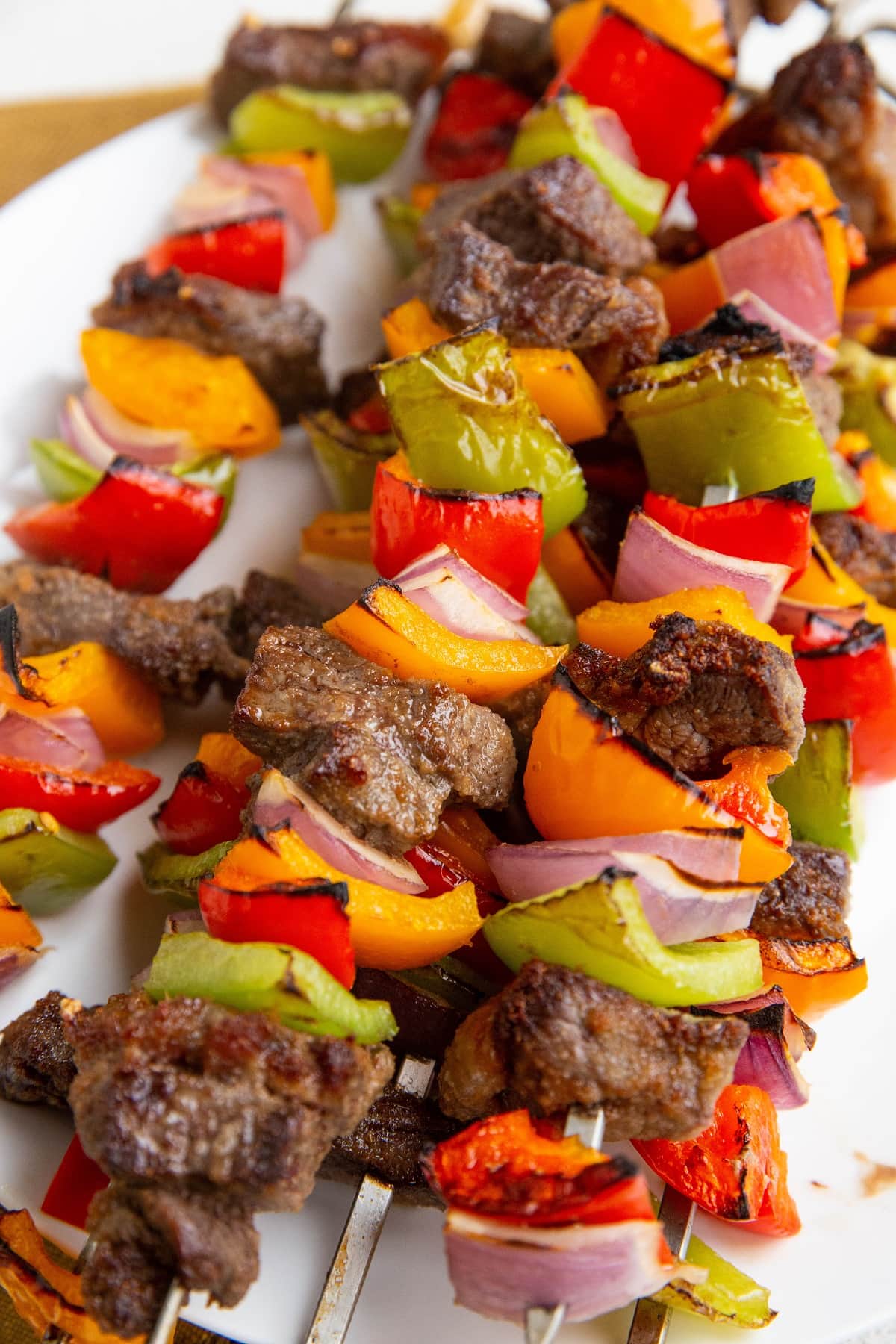 Beef kabobs on a plate, ready to serve.
