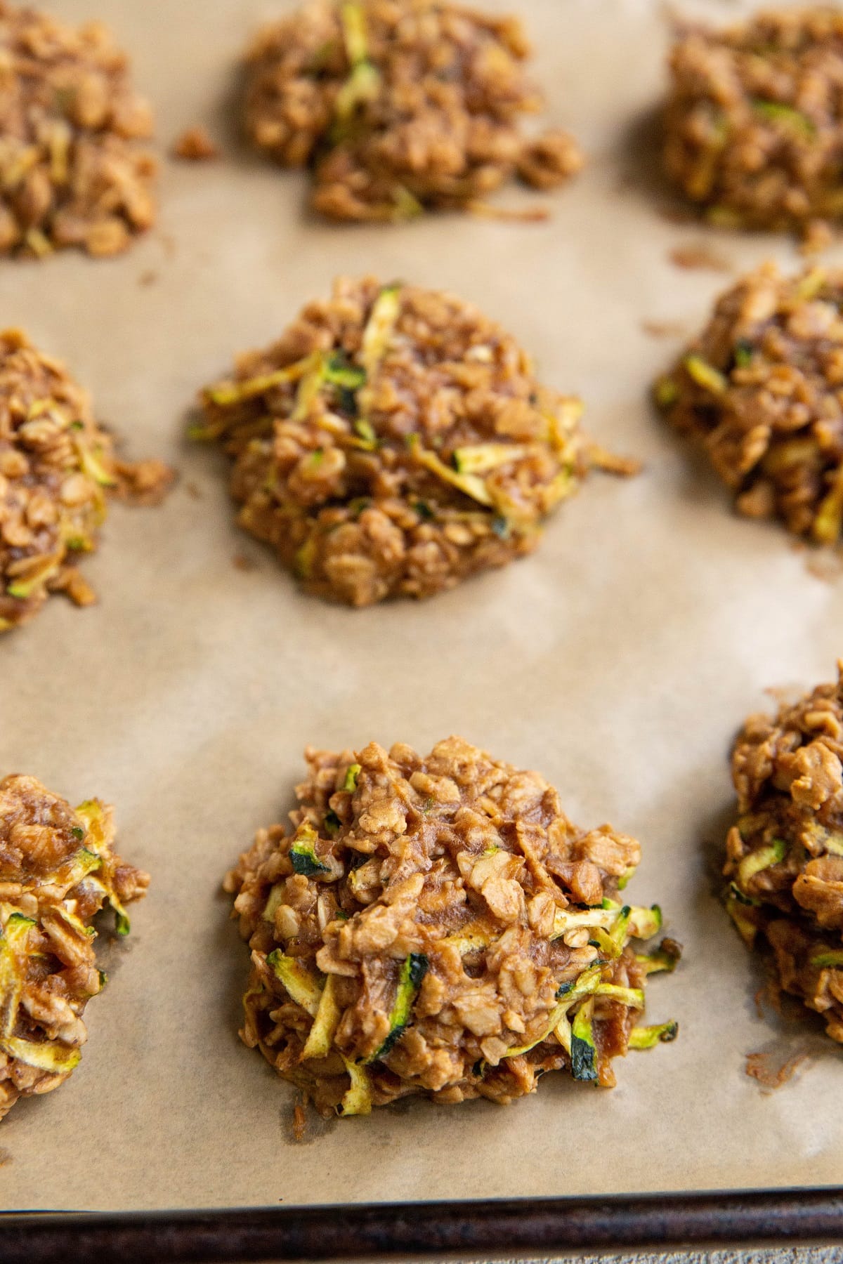 Oatmeal zucchini cookies fresh out of the oven on a baking sheet.