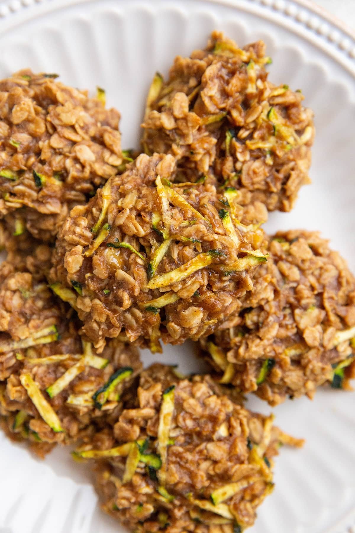 White plate with oatmeal zucchini cookies on top.