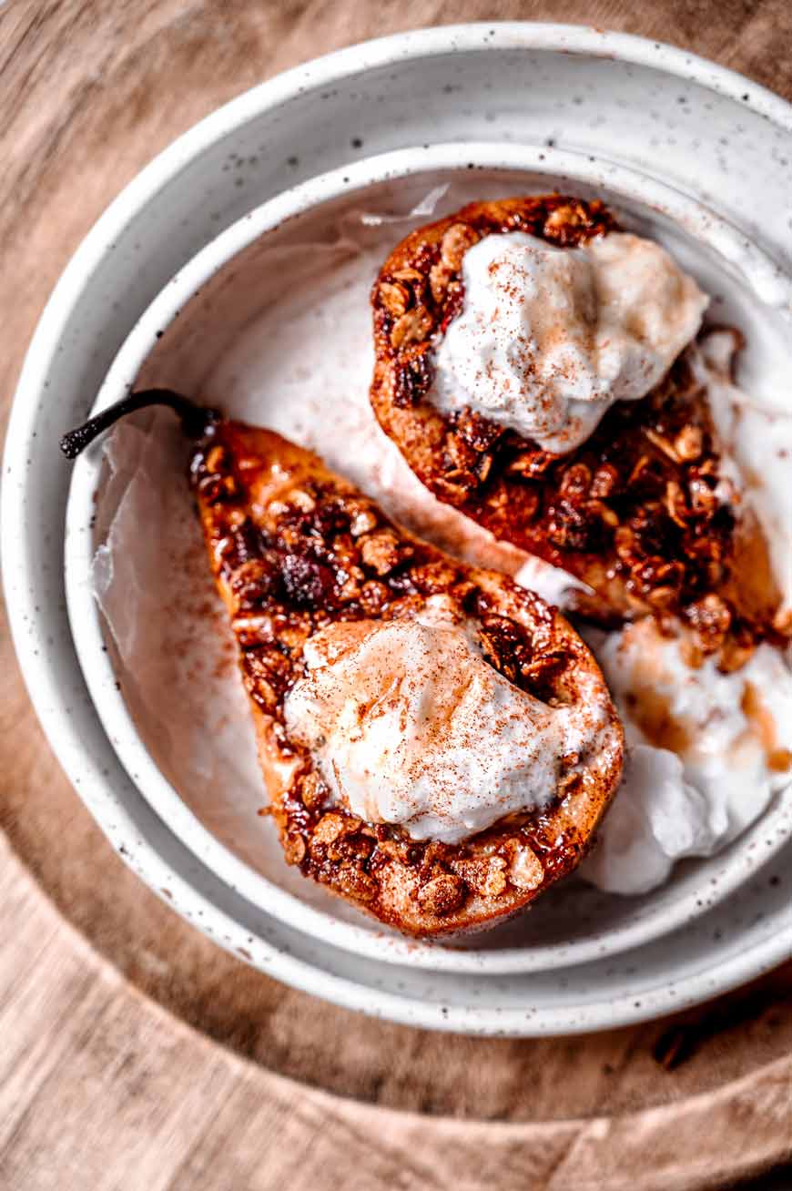 Pears in a white bowl with yogurt on top