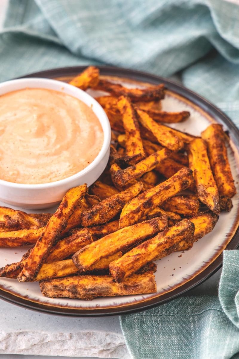 Sweet potato fries on a plate with dipping sauce