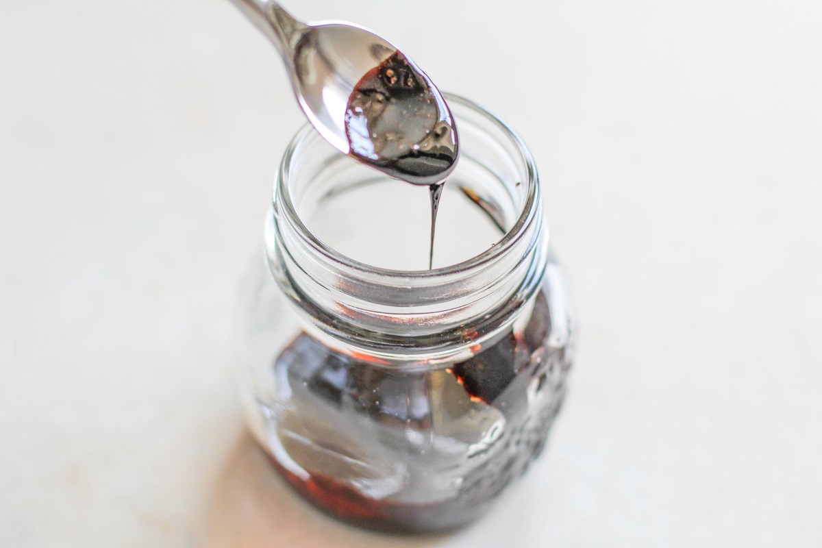 Balsamic reduction sauce in a small jar.