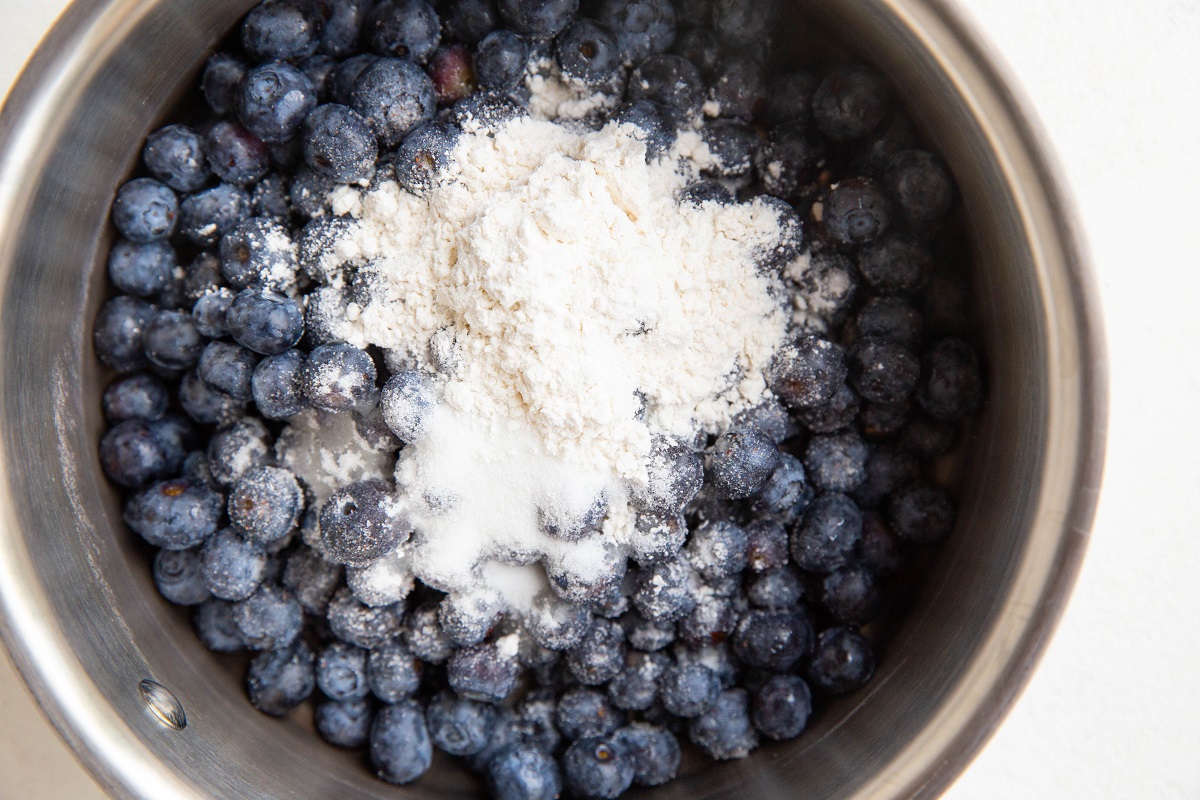 blueberries, flour, and sugar in a saucepan to make blueberry filling.