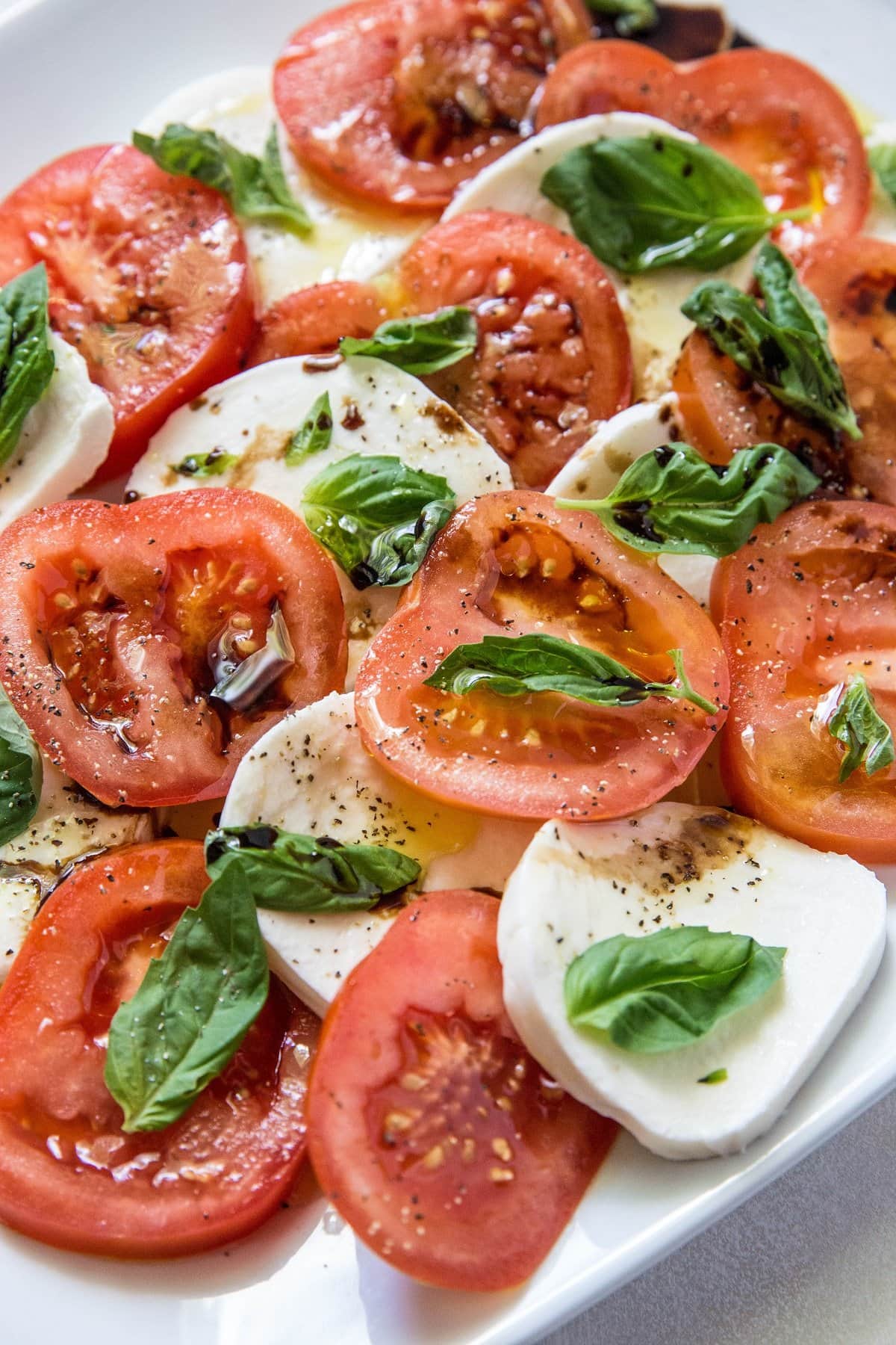 Caprese salad on a white platter for serving as an appetizer