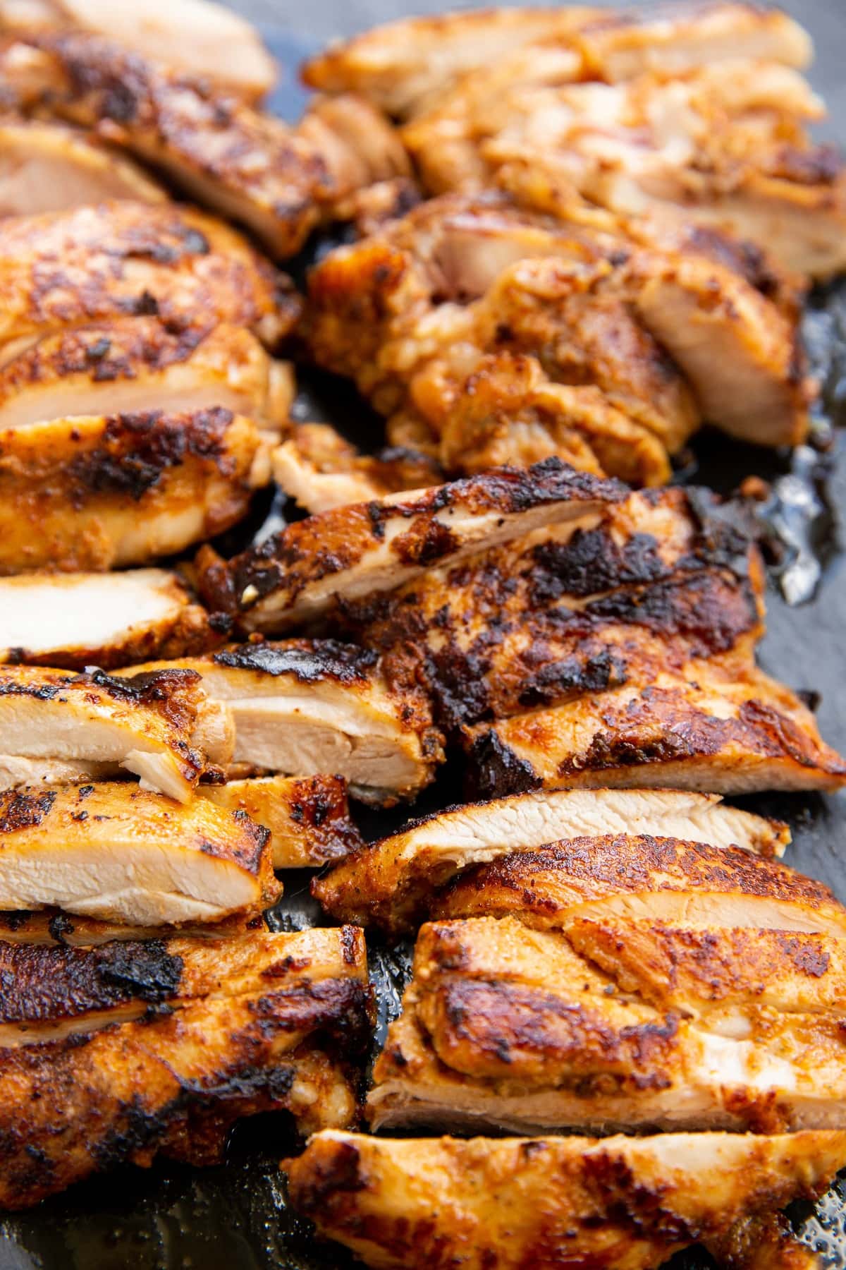 Sliced chicken on a cutting board.