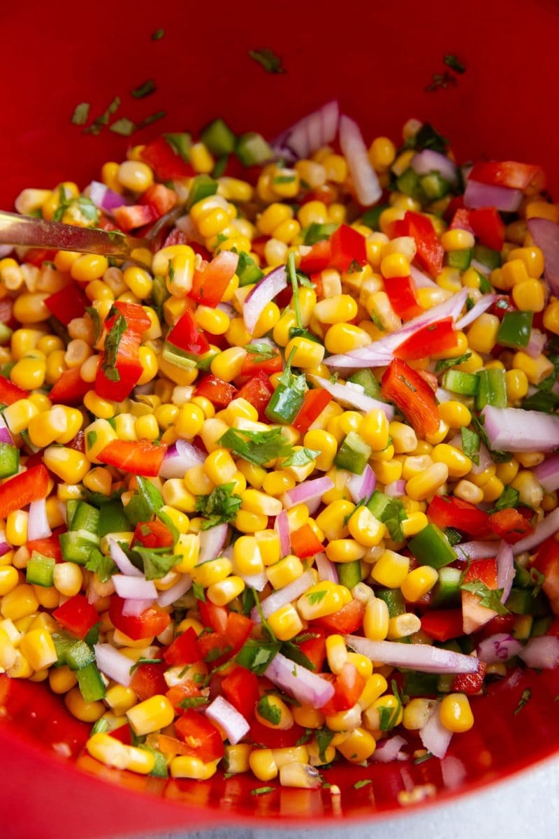 Corn Salsa in a red bowl, ready to be used on any main dish.