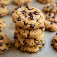 Stack of peanut butter cookies on a baking sheet.