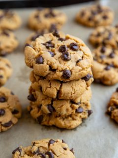 Stack of peanut butter cookies on a baking sheet.