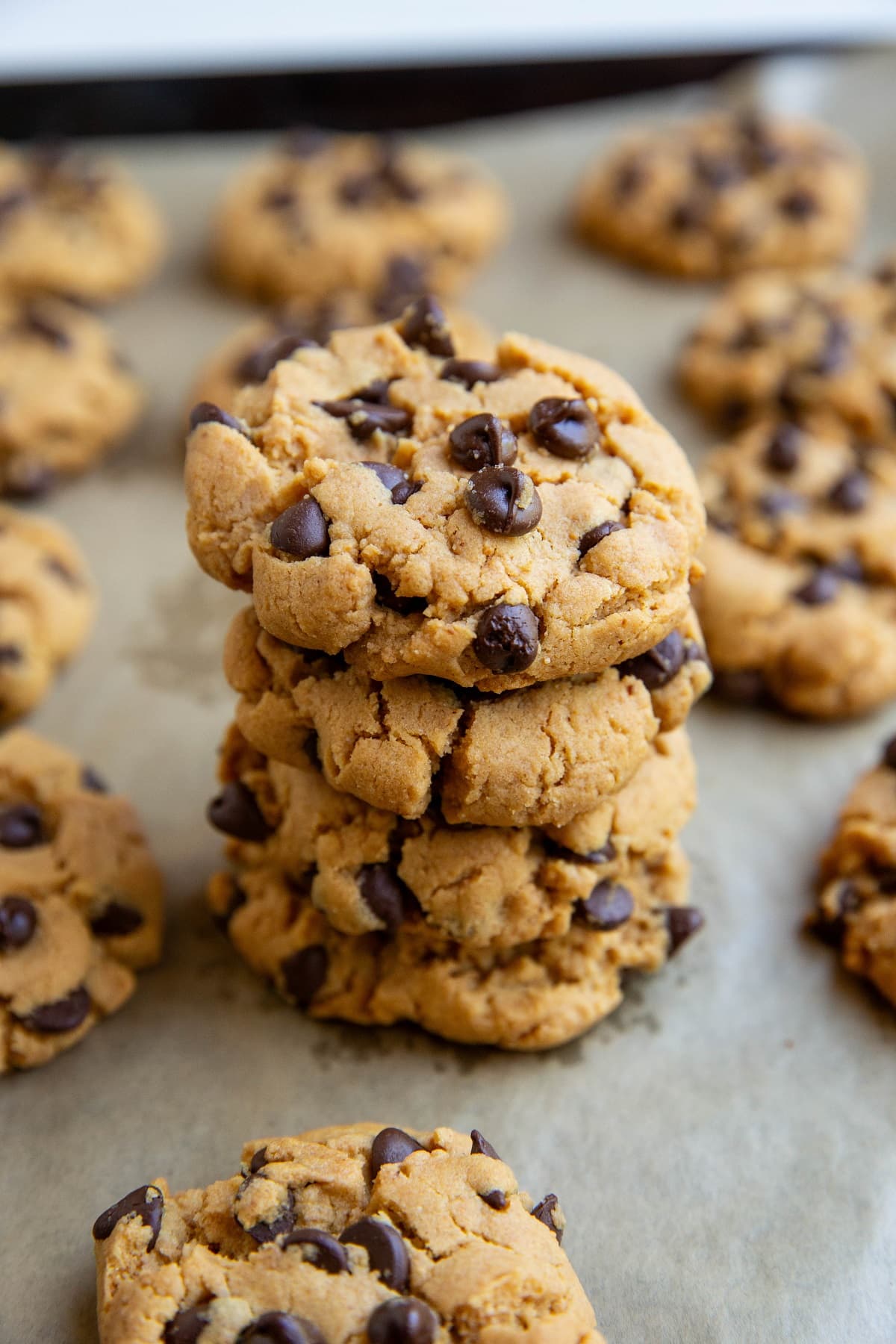 Stack of peanut butter cookies on a baking sheet.