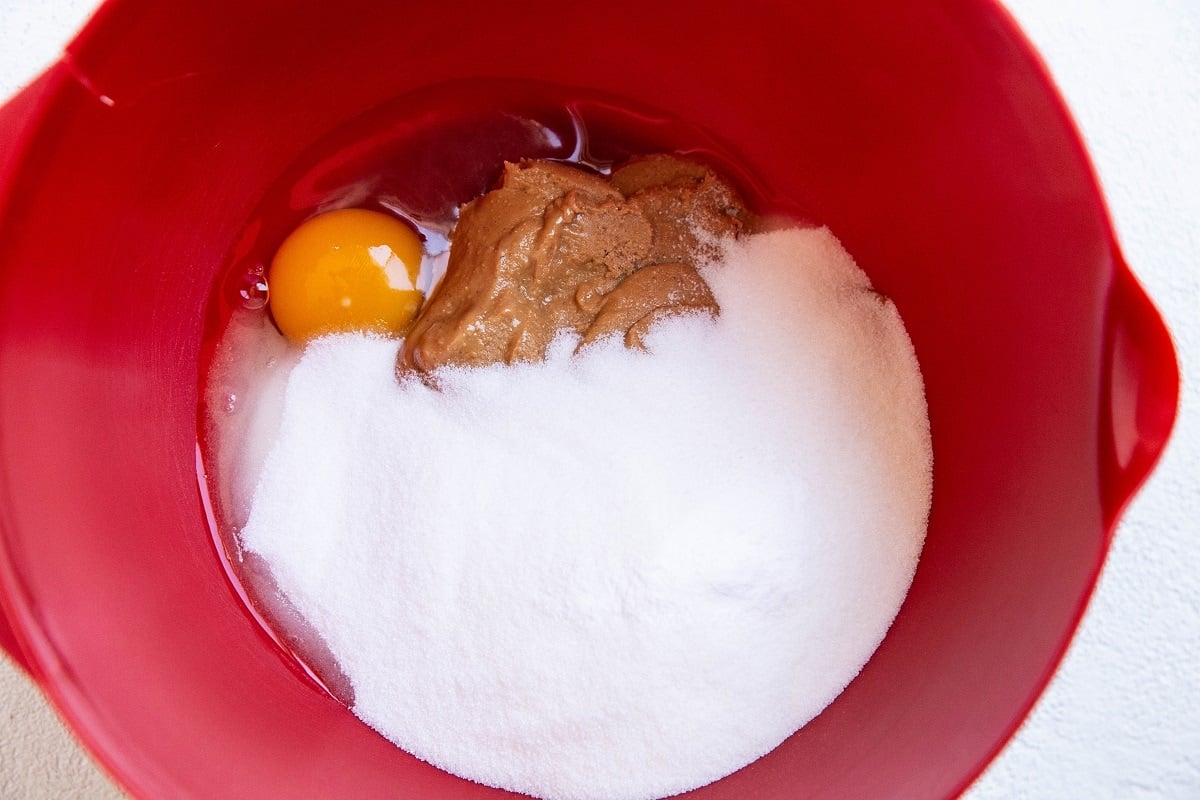 Ingredients for flourless peanut butter cookies in a mixing bowl.