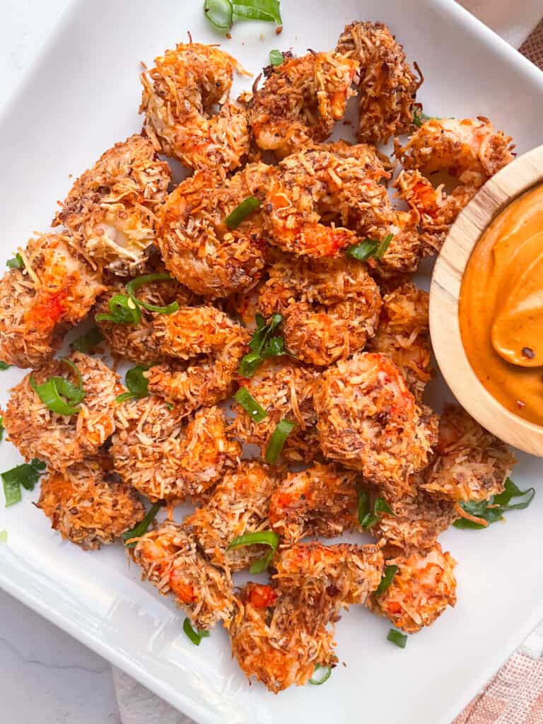 Plate of coconut shrimp with dipping sauce to the side